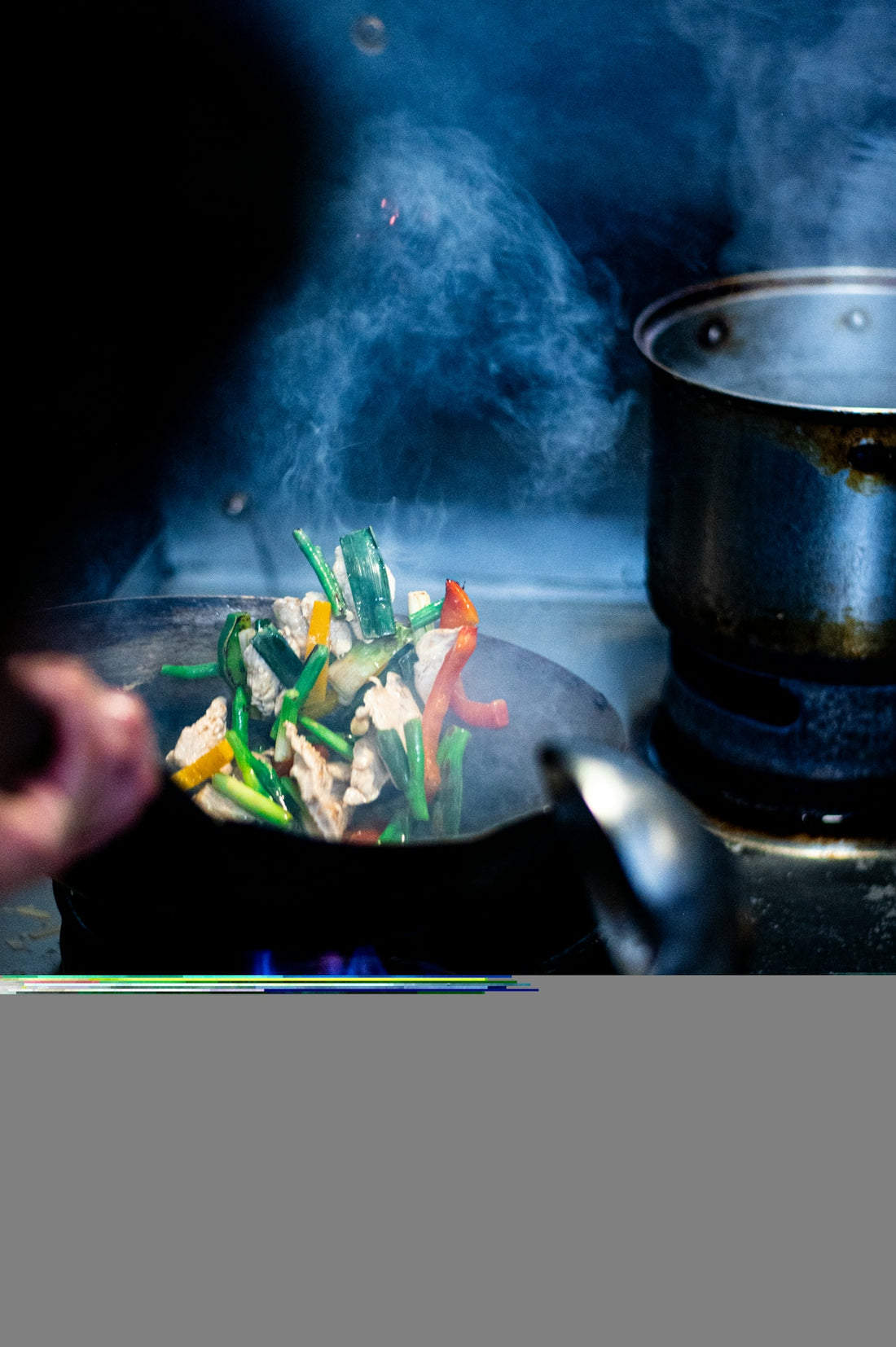 A person cooking food in a pot on a stove