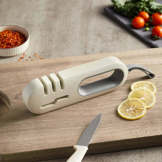4-in-1 Kitchen Knife Sharpener - Professional Multi-Functional Blade Sharpening Tool with Non-Slip Base on a wooden cutting board.